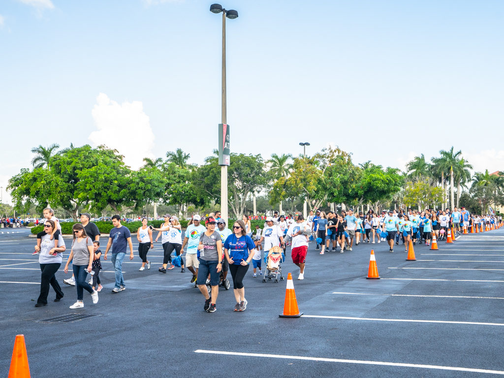 Petland Pembroke Pines team walking in parking lot at Autism Speaks Walk.