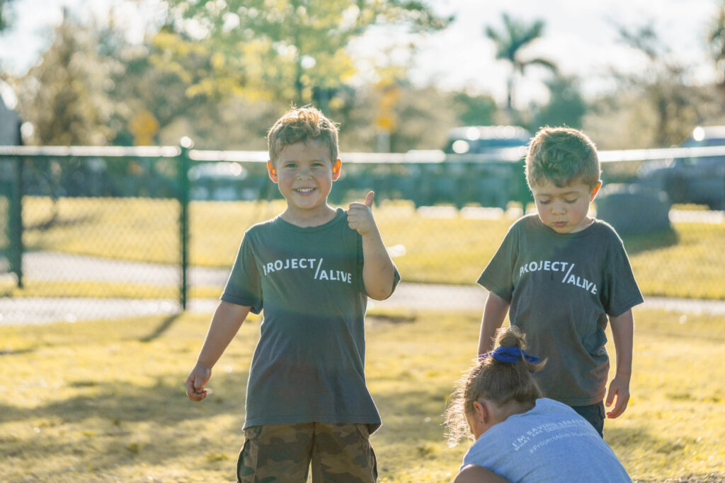 Children having fun and looking at the camera while at Petland puppy playdate.