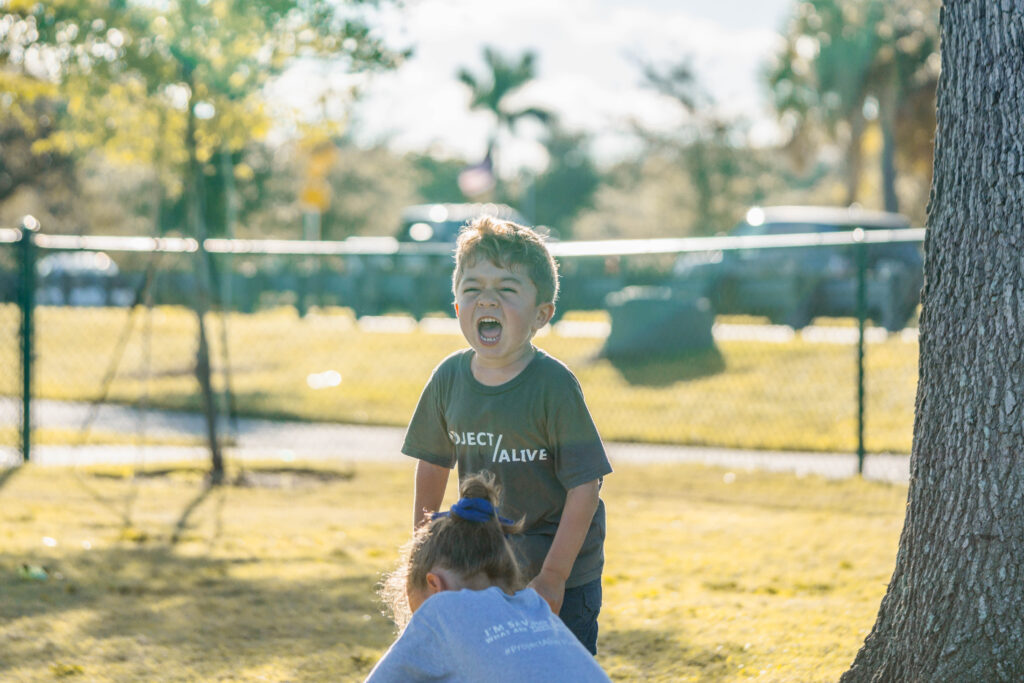 Child with Hunter's Syndrome having fun with puppy at Petland puppy playdate.