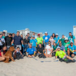 Petland Pembroke Pines picture of Petland and WOW Center team members standing on Miami beach for beach clean up.