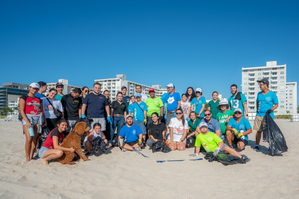 Petland Pembroke Pines picture of Petland and WOW Center team members standing on Miami beach for beach clean up.