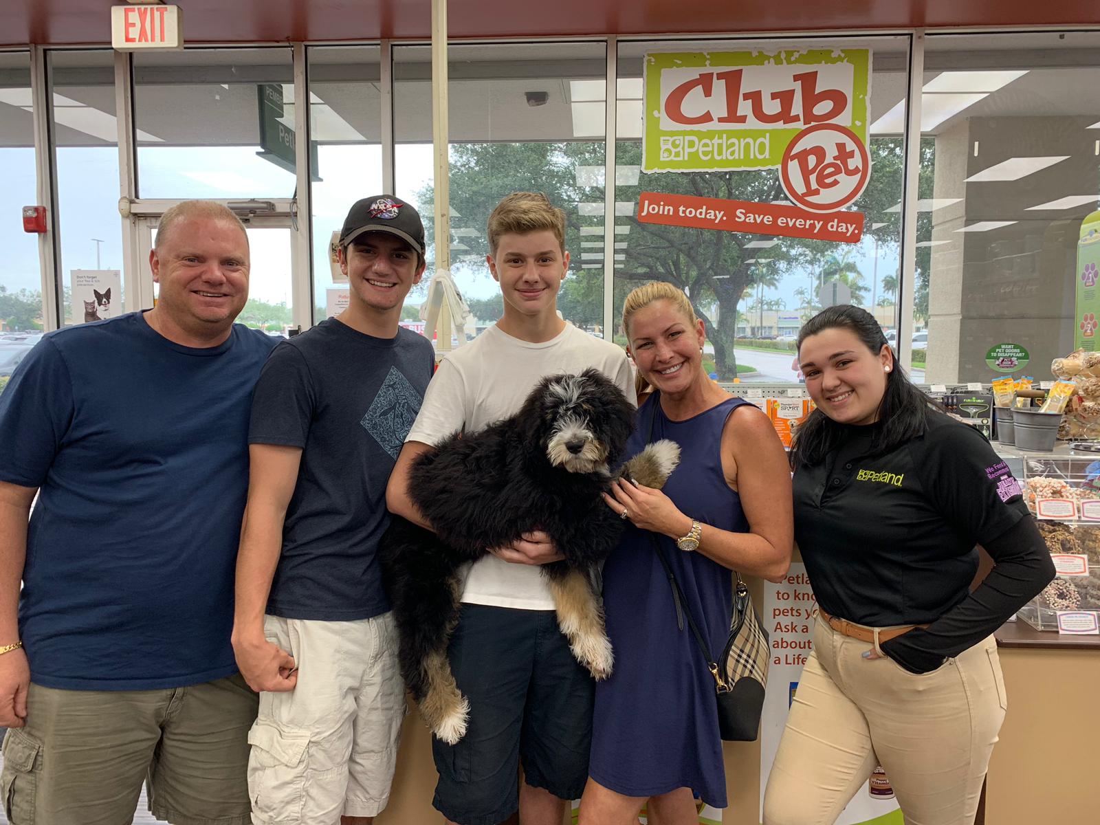 Petland Pembroke Pines picture of family of Marjory Stoneman Douglas High School survivor holding their cute Petland puppy.