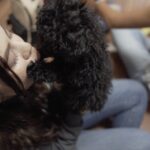 Petland Pembroke Pines picture of Refuge Student Ministry student holding a cute Petland puppy.