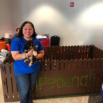 Petland Pembroke Pines picture of Veterans Outreach Day participant holding a cute Petland puppy.