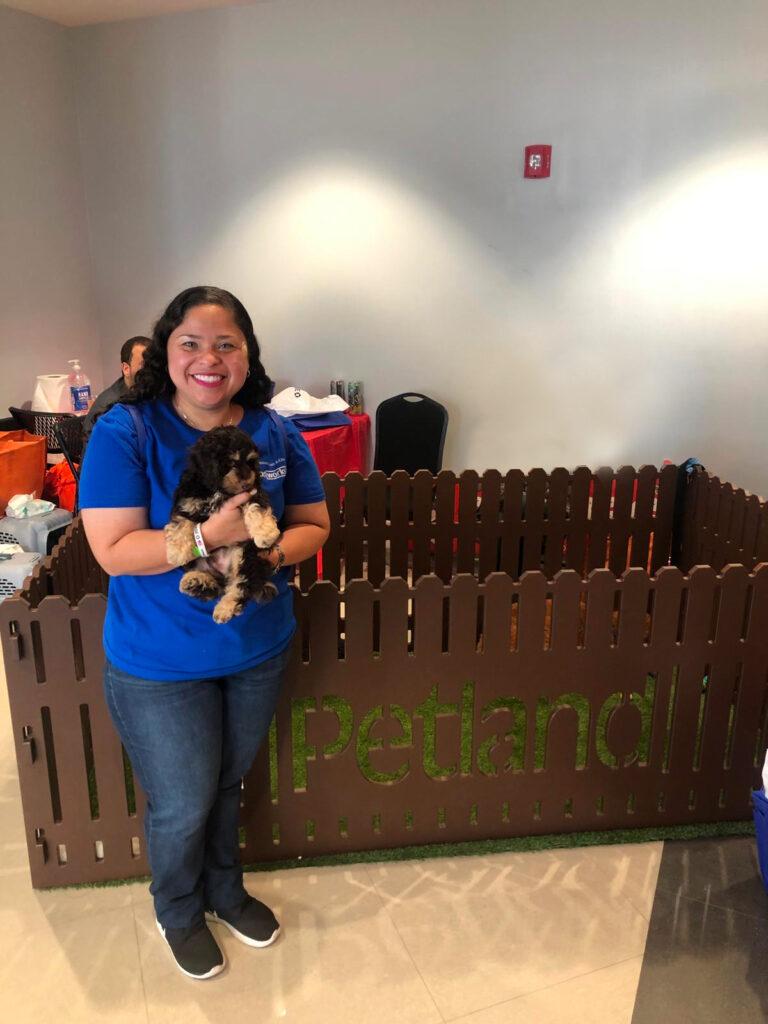 Petland Pembroke Pines picture of Veterans Outreach Day participant holding a cute Petland puppy.