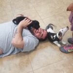 Petland Pembroke Pines picture of Disability Achievement Center patients playing with cute Petland puppies on the floor.