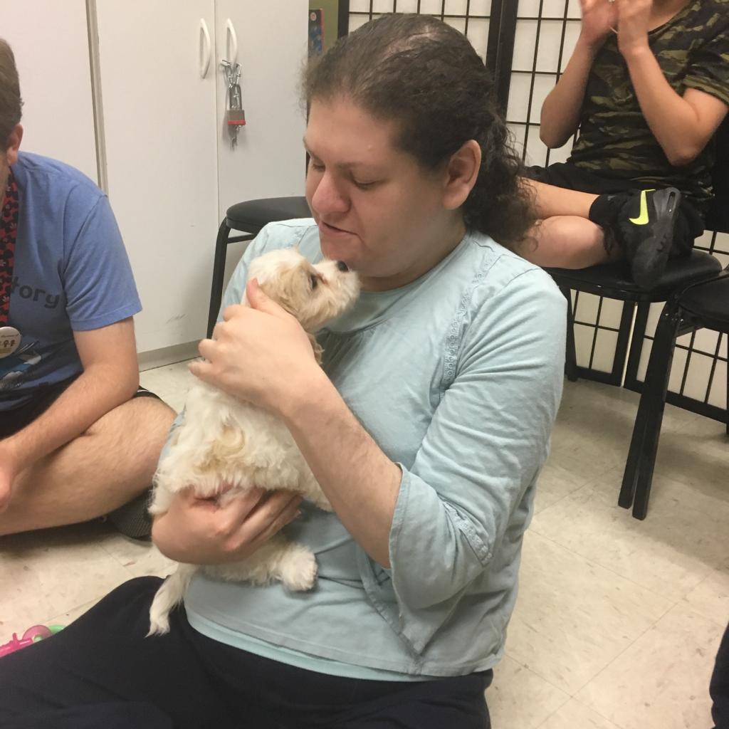 Petland Pembroke Pines picture of patient holding Petland puppy ay Little Flowers of Hope.