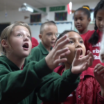 Petland Pembroke Pines picture of Crayons Christian School students at puppy playtime session with Petland puppies.