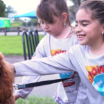 Petland Pembroke Pines picture of Goldendoodle puppy, Jax with Miami Power Team children.