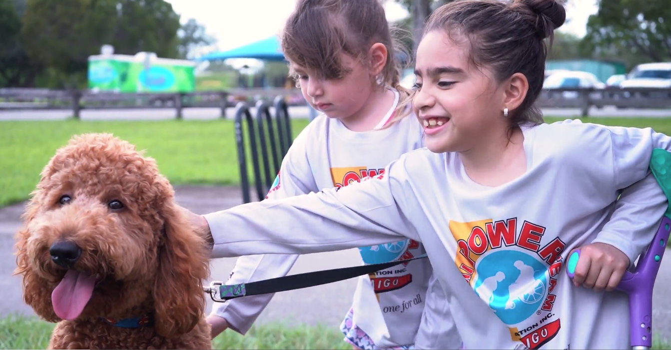 Petland Pembroke Pines picture of Goldendoodle puppy, Jax with Miami Power Team children.