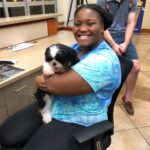 Petland Pembroke Pines picture of Nova Campus student holding a cute Petland puppy at NSU campus.