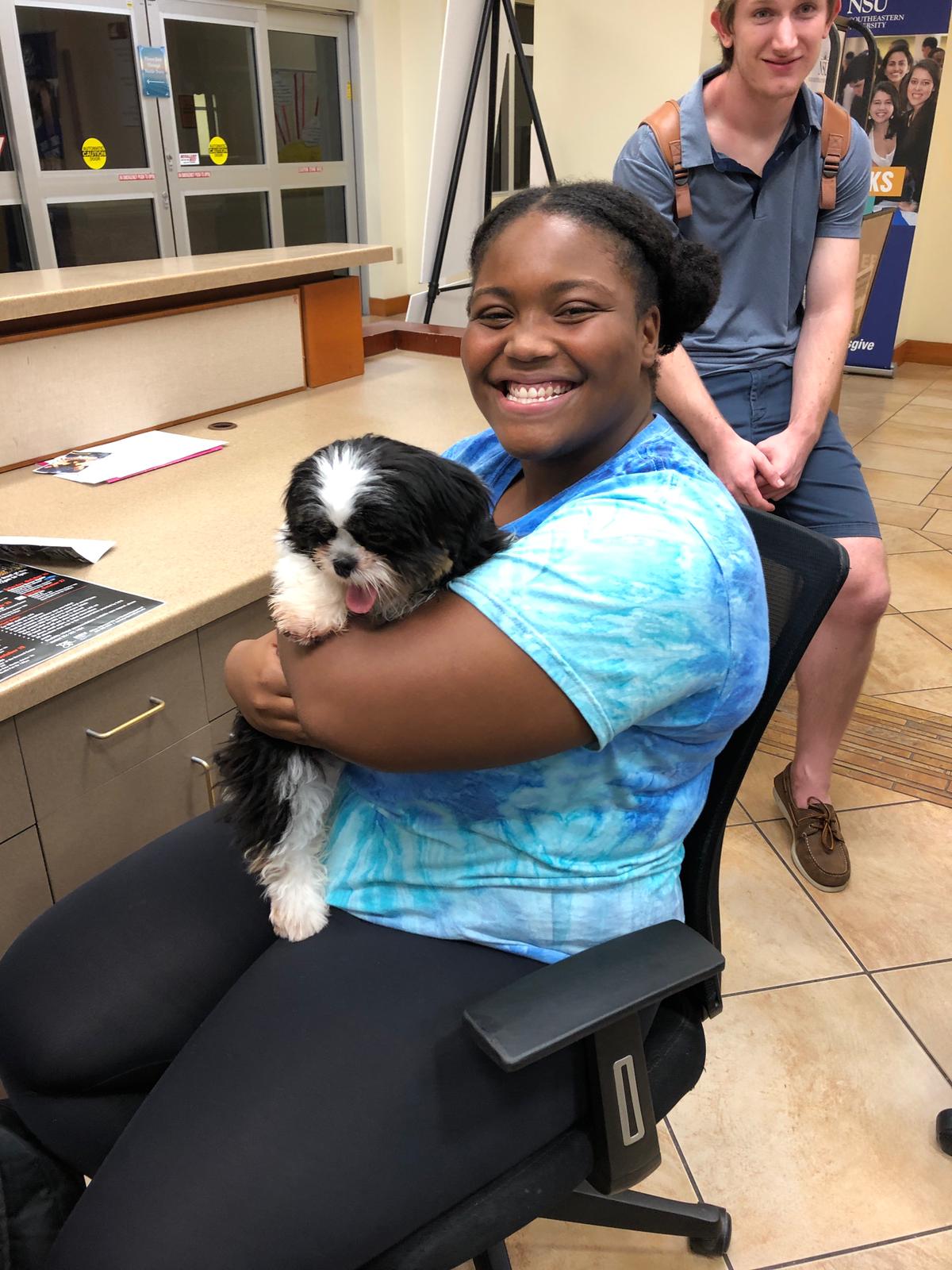Petland Pembroke Pines picture of Nova Campus student holding a cute Petland puppy at NSU campus.