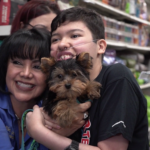 Petland Pembroke Pines picture of Sebastian holding a cute Yorkie puppy from Petland Kendall.