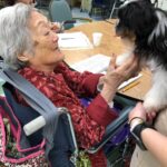 Petland Pembroke Pines picture of patient holding puppy at Southwest Focal Point Senior Center.