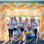 Picture of Petland Pembroke Pines team posing in front of St. Jude Walk/Run entrance.