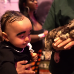 Petland Pembroke Pines picture of baby with cute Petland puppy at Boo-ville event.