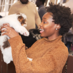 Petland Pembroke Pines picture of a cute puppy from petland being held by a visitor at Children's Holiday in the Pines.
