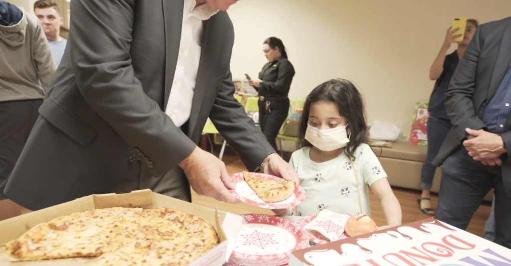 Petland Pembroke Pines picture of a young patient from Holtz Children's Hospital getting pizza.