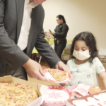 Petland Pembroke Pines picture of a young patient from Holtz Children's Hospital getting pizza.