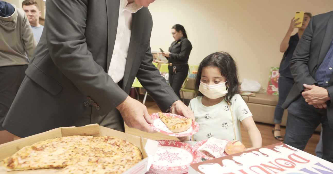 Petland Pembroke Pines picture of a young patient from Holtz Children's Hospital getting pizza.