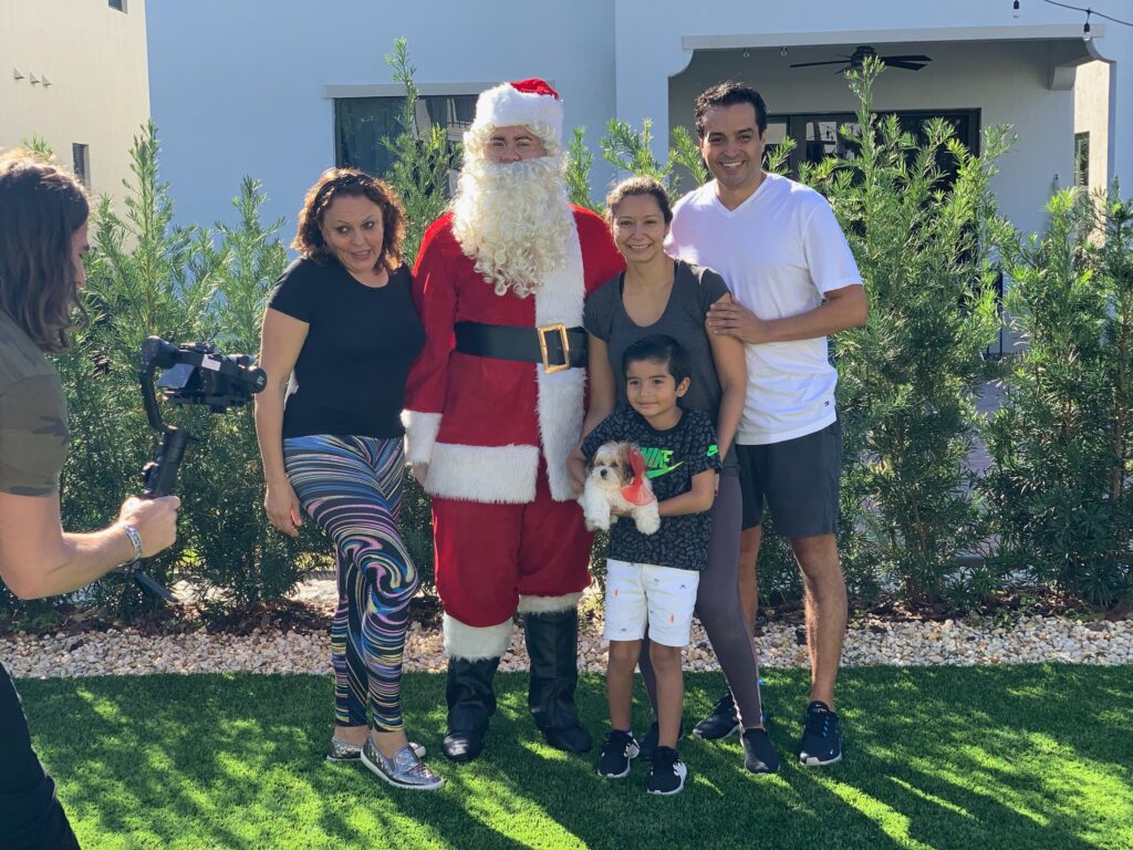 Petland Pembroke Pines picture of Santa Claus and family posing with Petland puppy for a picture.