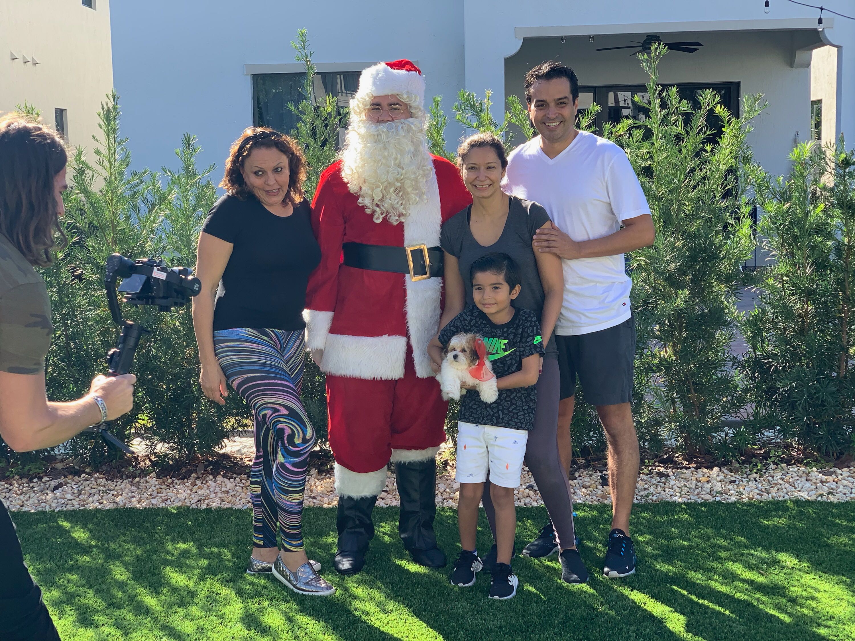 Petland Pembroke Pines picture of Santa Claus and family posing with Petland puppy for a picture.
