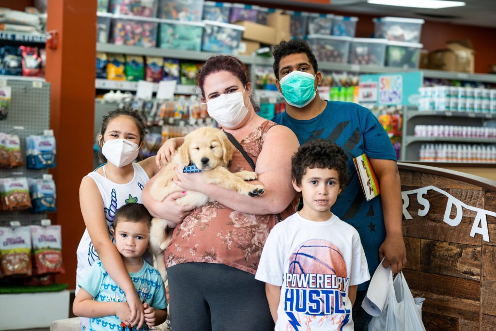 Petland Pembroke Pines picture of Erick Arietta and his family posing with their new puppy.