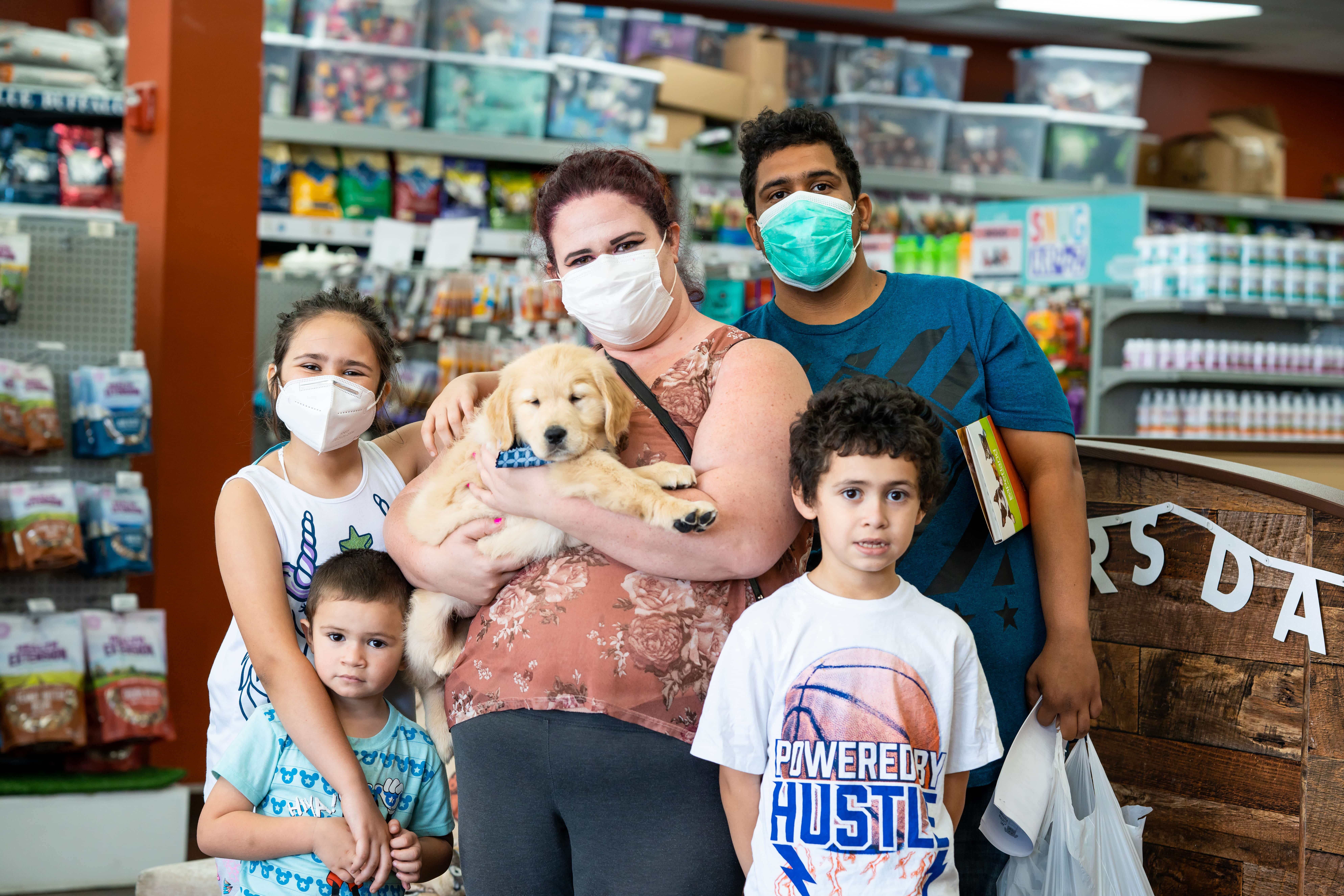 Petland Pembroke Pines picture of Erick Arietta and his family posing with their new puppy.
