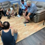 Petland Pembroke Pines picture of NAMI rehab center patients playing with cute Petland puppies for puppy therapy.