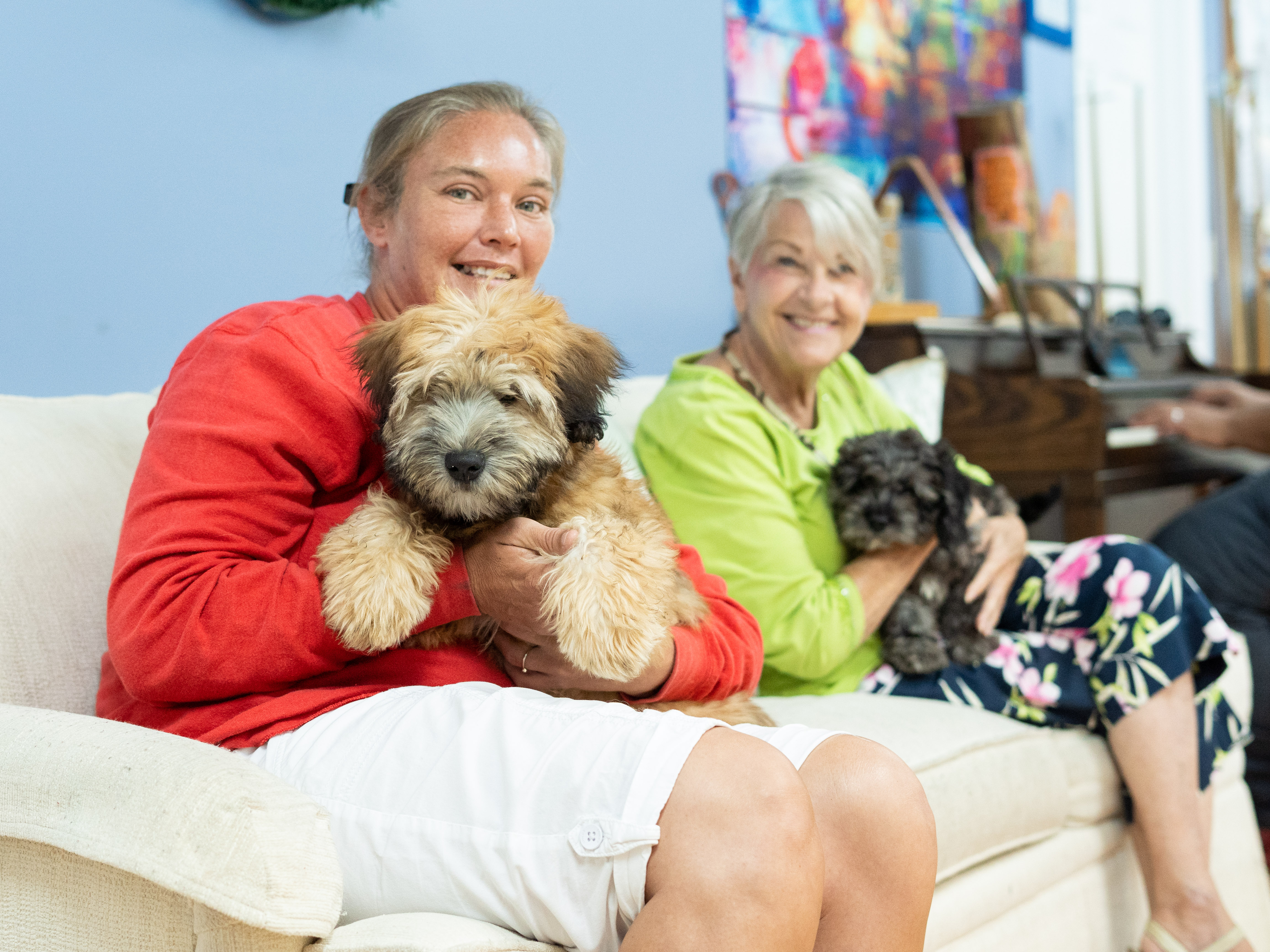 residents of NAMI Center holding cute puppies from Petland Pembroke Pines.