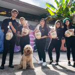 A group of volunteers from Petland Pembroke Pines standing with turkeys for a donation event at the WOW Center.