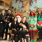 Southwest Focal Point Center community taking a picture with Santa and Petland puppies.