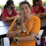 A woman from the WOW Center holds a cute puppy from Petland.