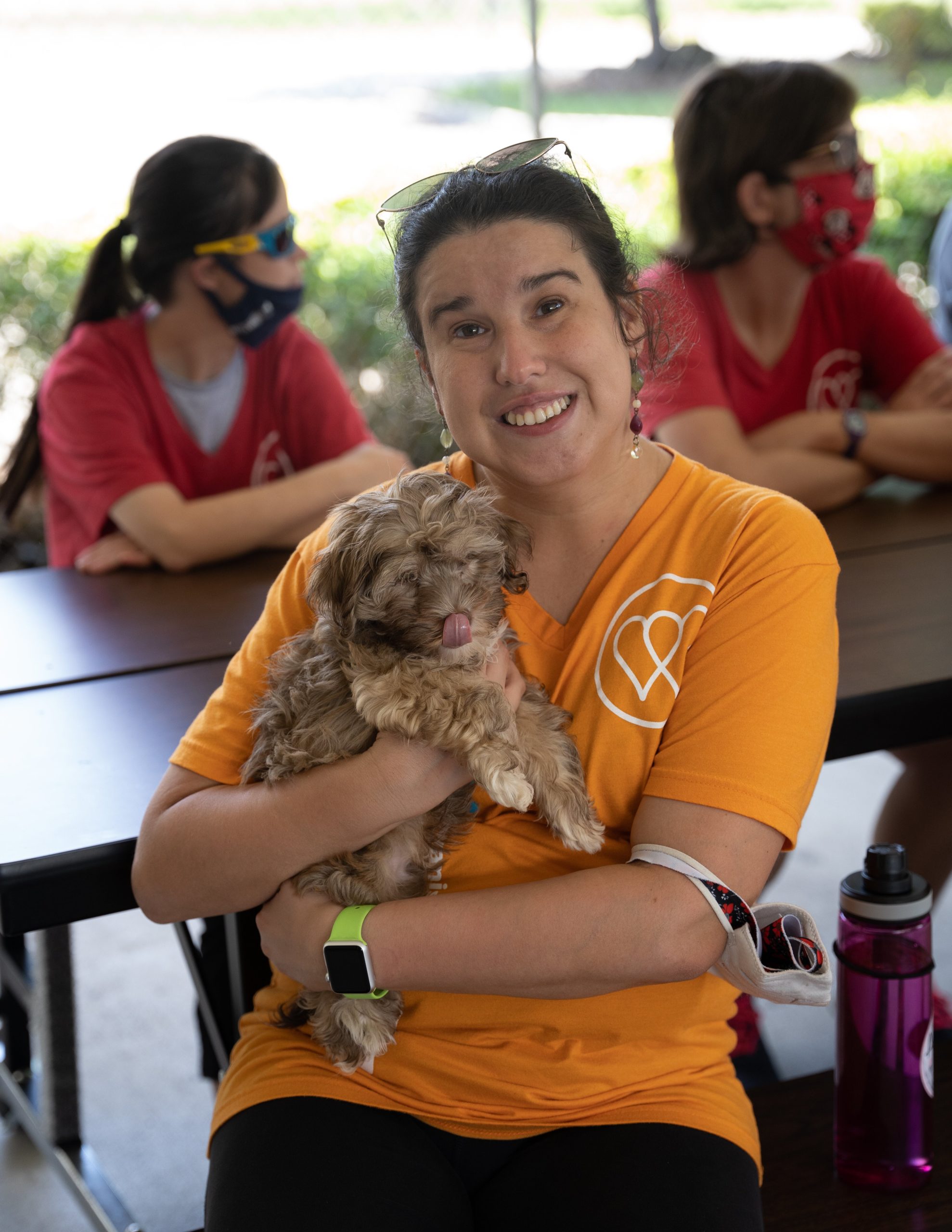 A woman from the WOW Center holds a cute puppy from Petland.